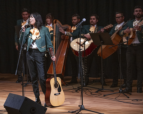 Female singer performing with Mariachi Los Broncos on stage