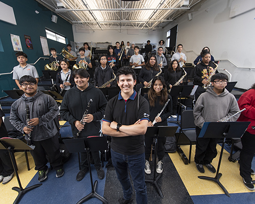 Music alum Jose Patiño with his high school band students