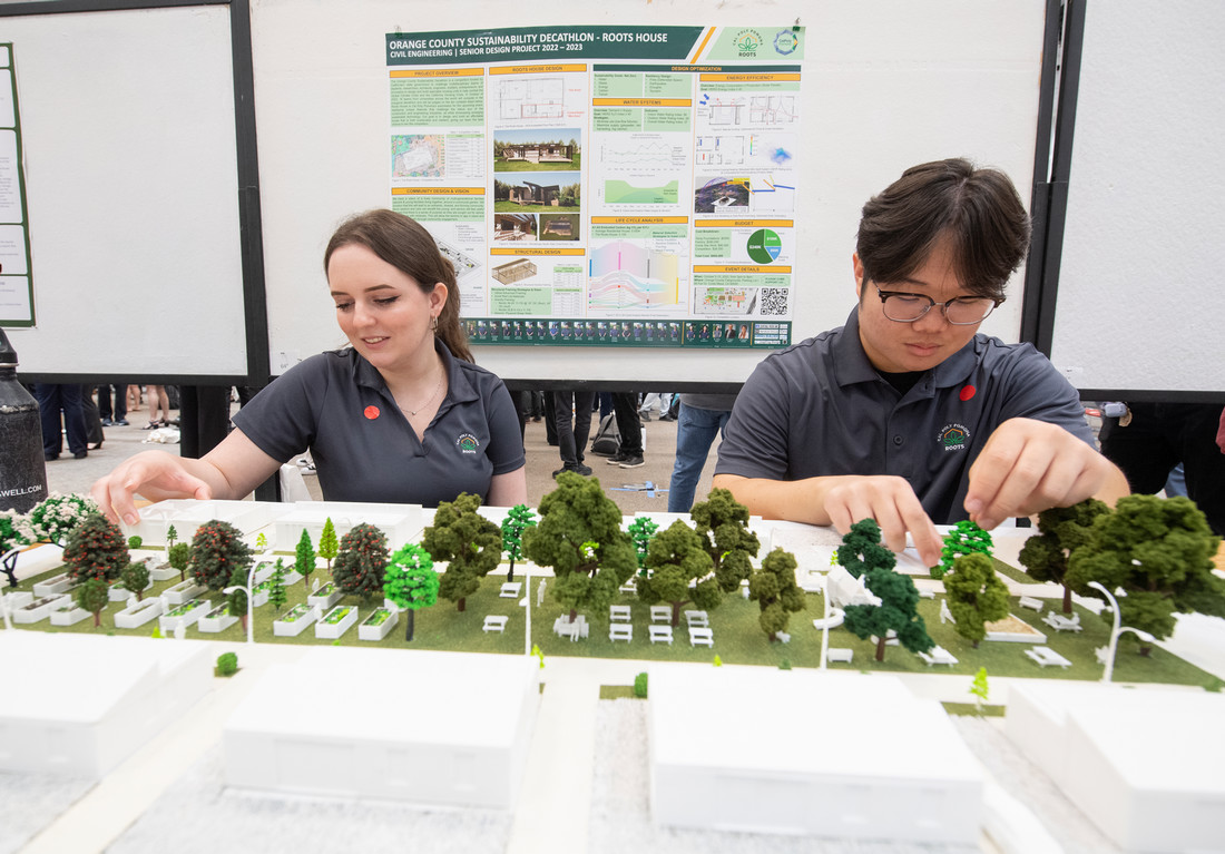 students tinkering with model of an urban space