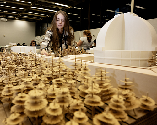Architecture student working on her model