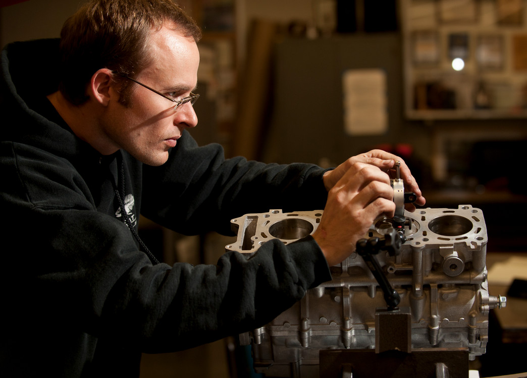 student tinkering with an engine