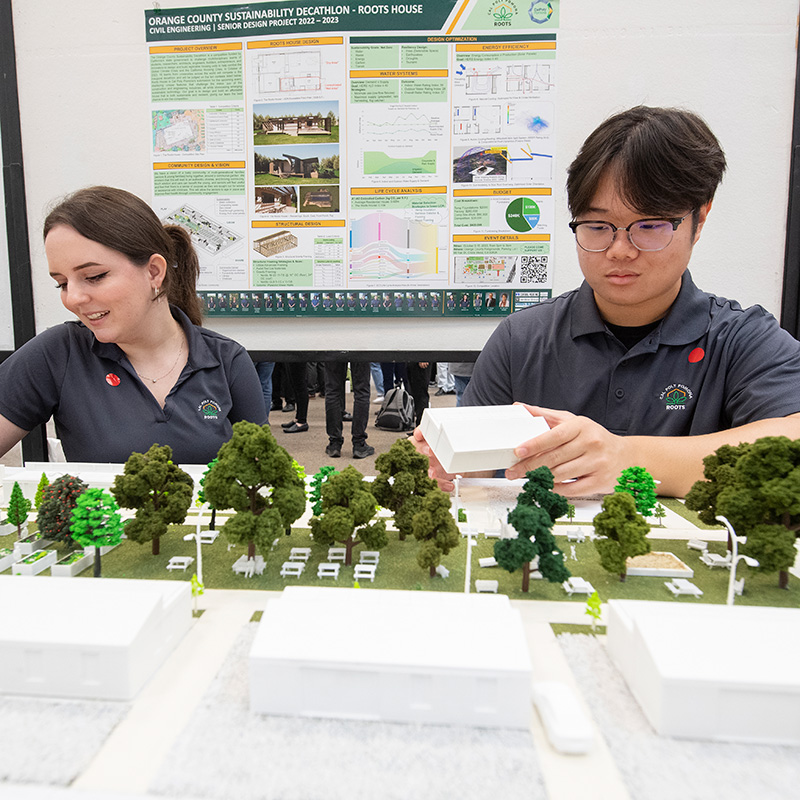 Students work on replica of the Roots House 