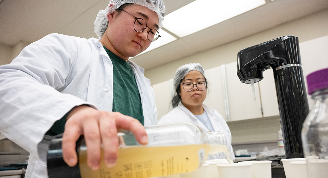 Two students work with taste testing samples