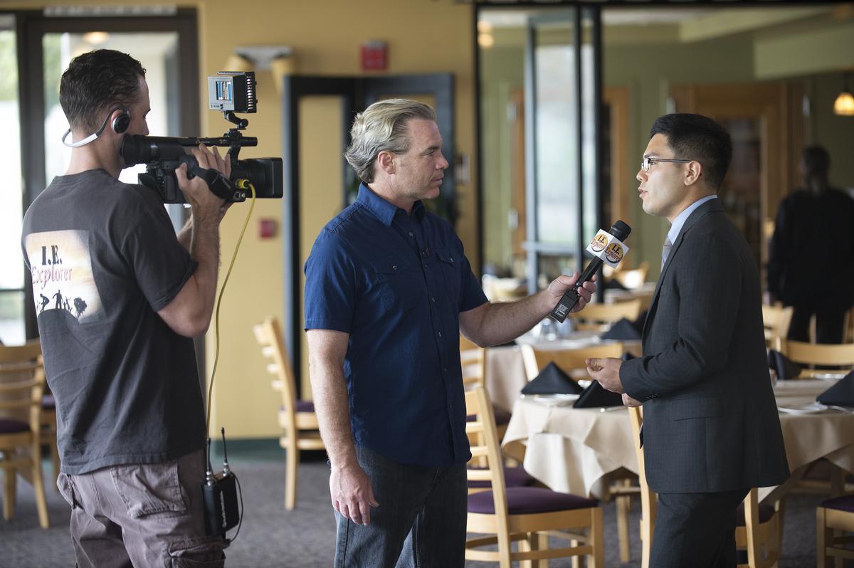 A male student is interviewed on camera.