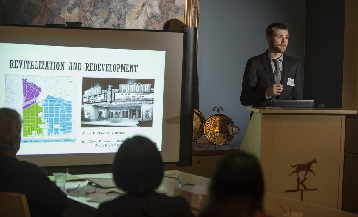 Male student standing in podium giving a presentation