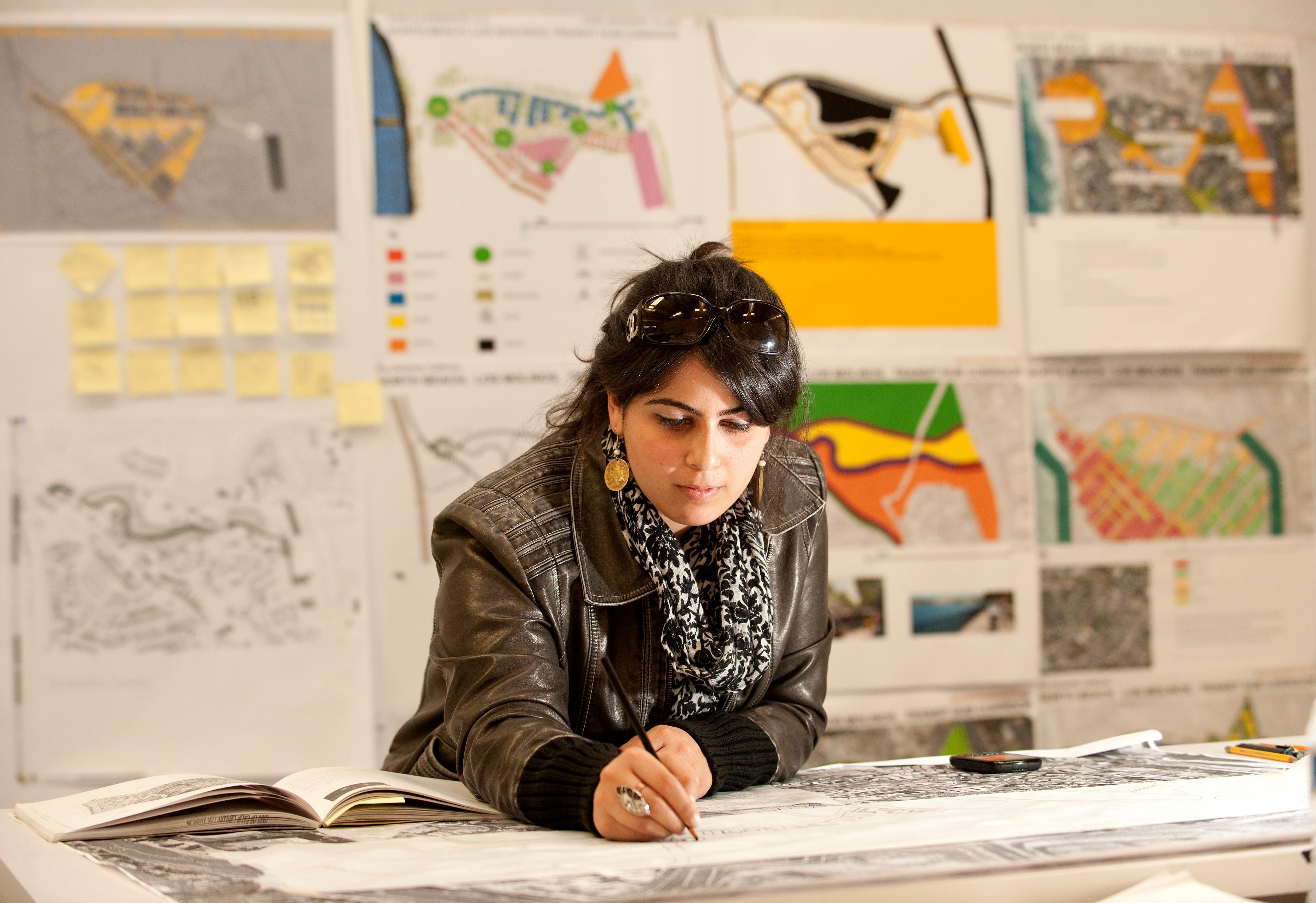 Architecture student maps out plans for urban planning.