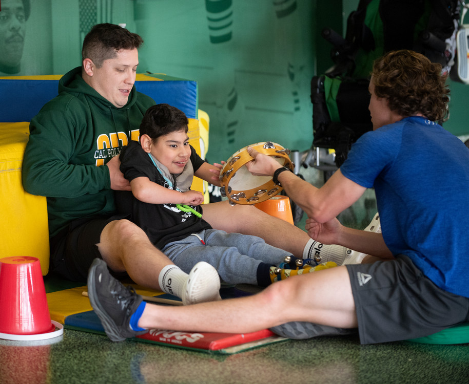 students helping child sit down