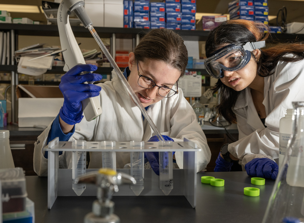 Idalina Bonham and Maia Taher working in a biotechnology lab