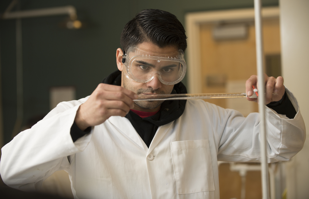 a student measuring a chemical