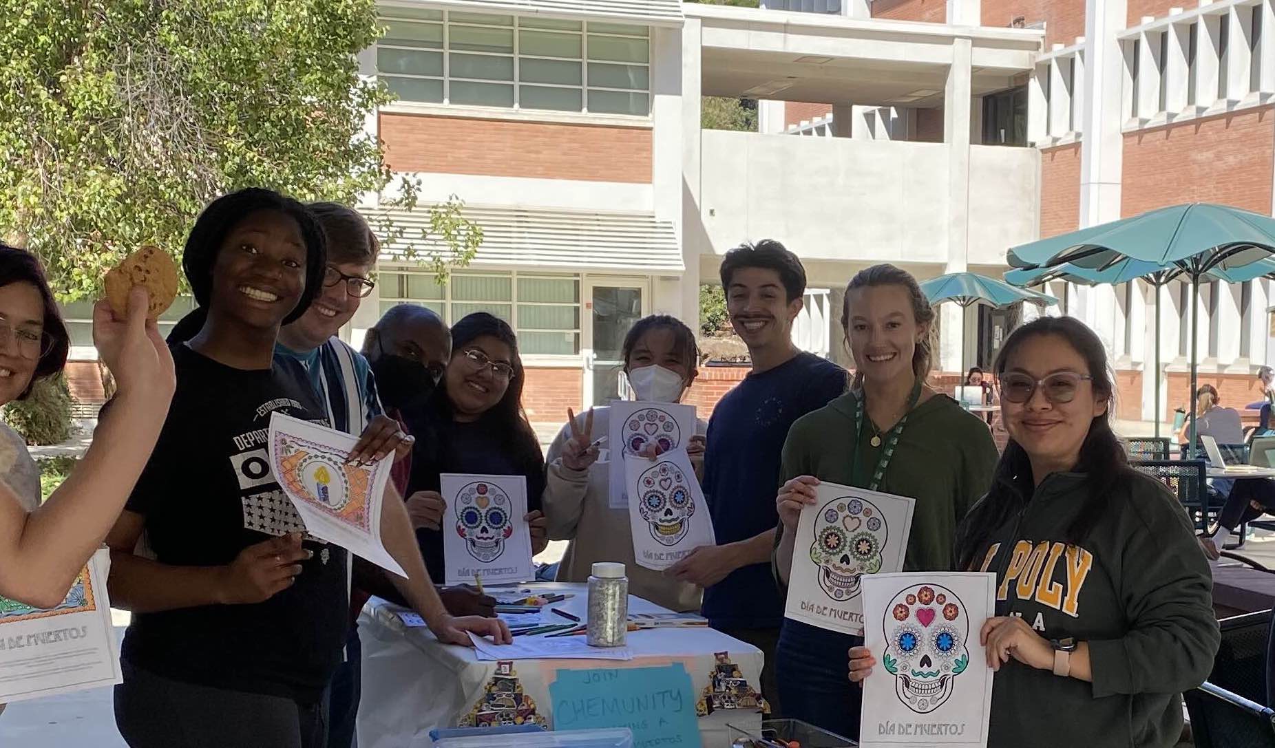 a group of students show off drawings
