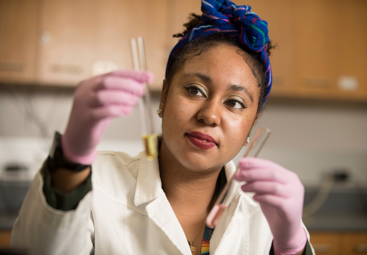 Nicole Parr looking through samples on test tube vials