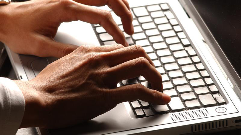 hands typing on keyboard