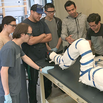 professor demonstrating energy storage system to students