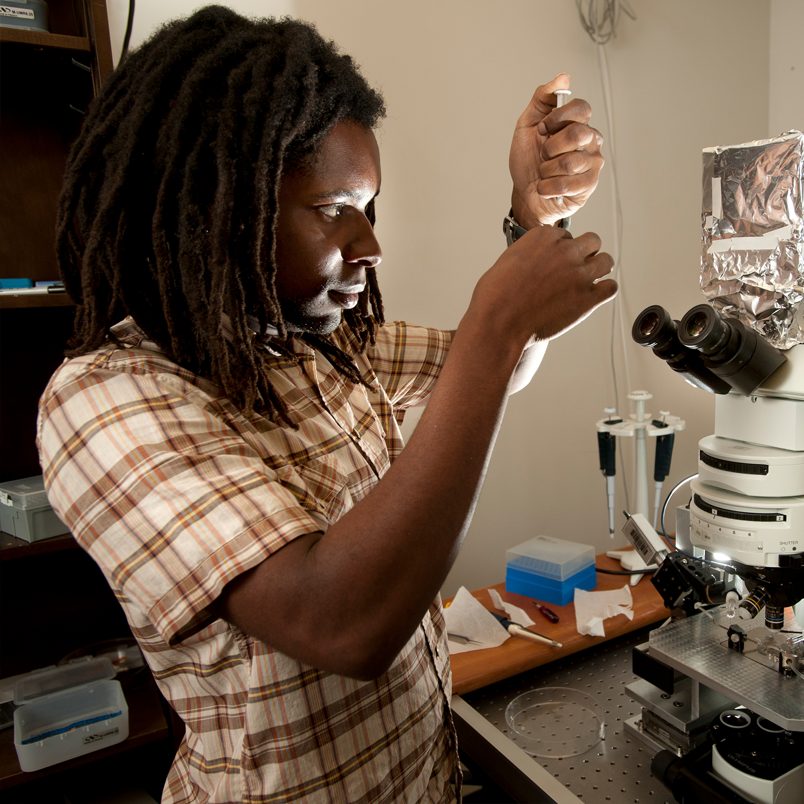 student looking at syringe in hand