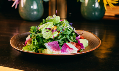 CPP Salad on a wooden plate indoors.