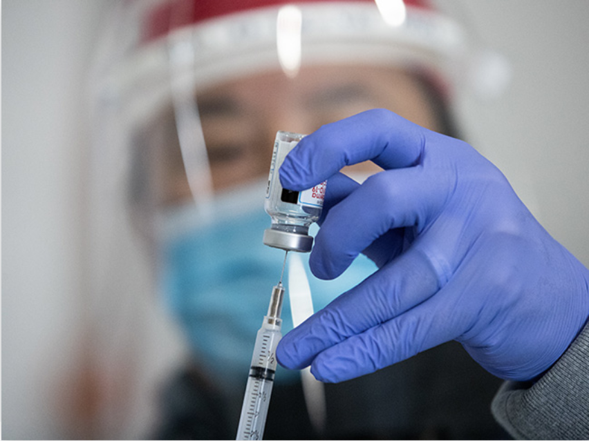 A nurse holds a COVID-19 Vaccine Vial