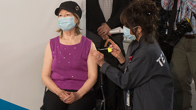 Woman receives COVID-19 vaccine at the mass vaccination hub at CPP.