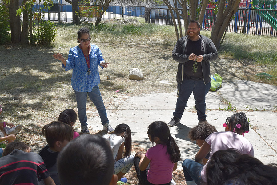 Prete Fellow Victor Celaya assists teacher Ms. Pena with a science lesson