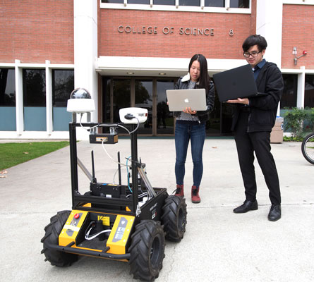 2 students in front of building 8