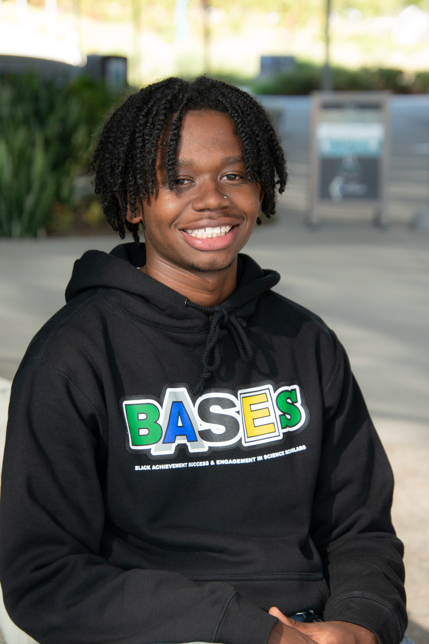 A BASES student smiles at the camera