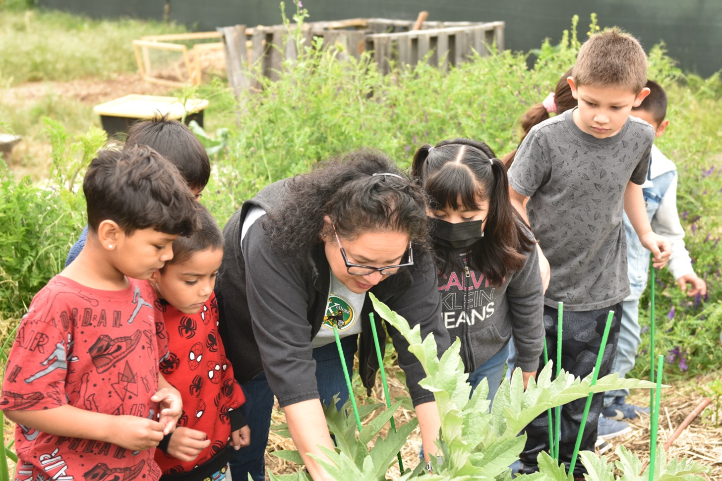 Dorough in the garden with kids while presenting