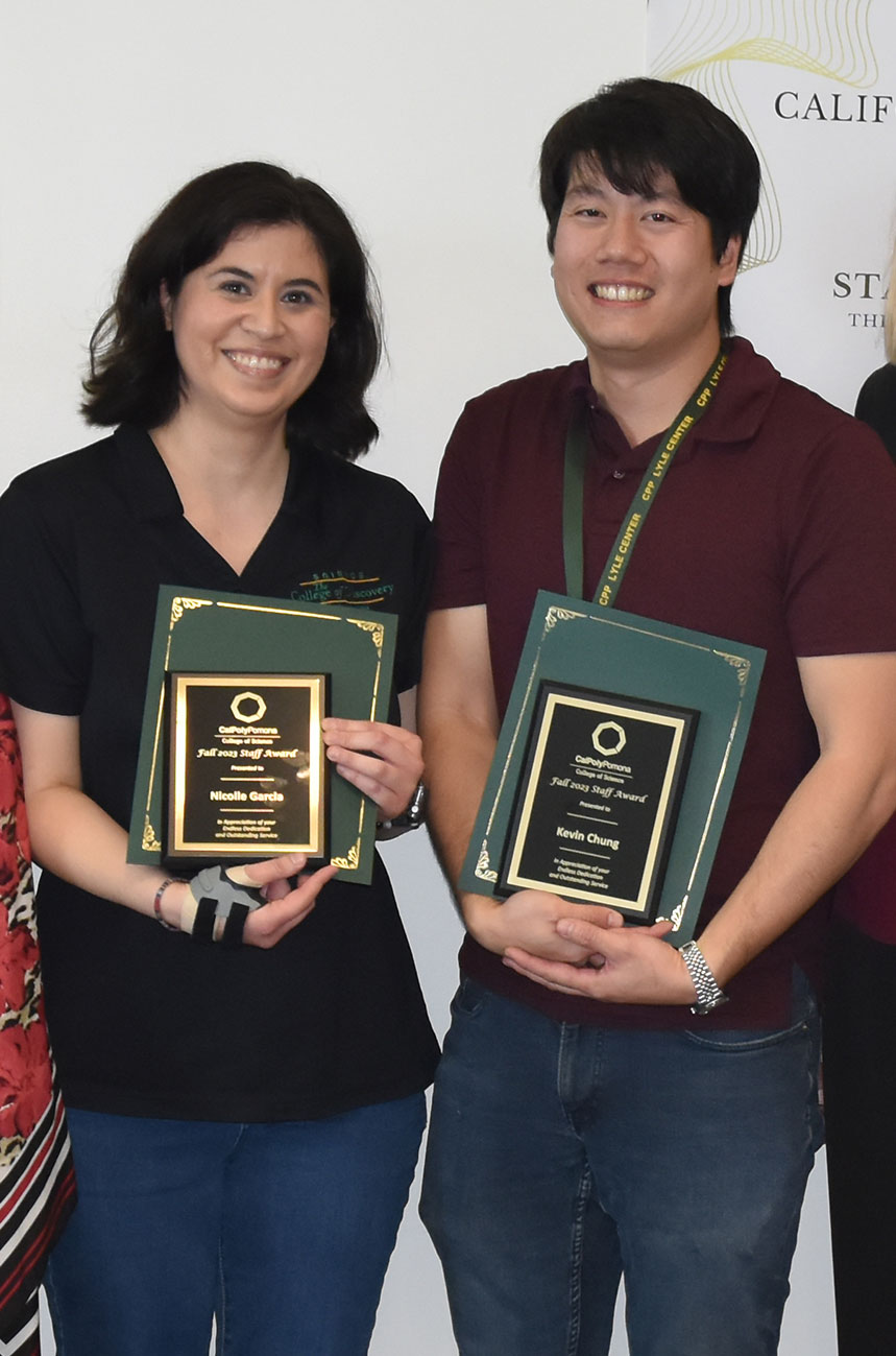 Nicolle Garcia and Kevin Chung holding their staff awards