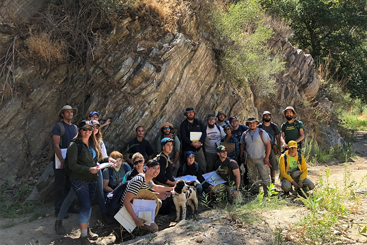 students in front of a rock formation