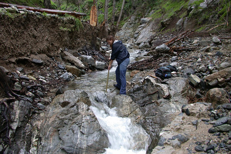 Student by a waterfall