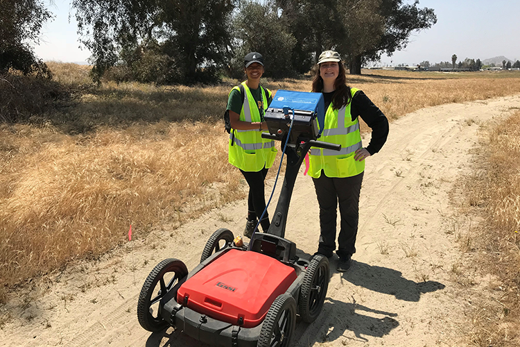 two students with an equipment