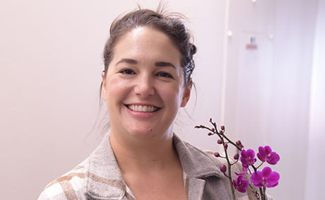 jasmine hyland holding an orchid.