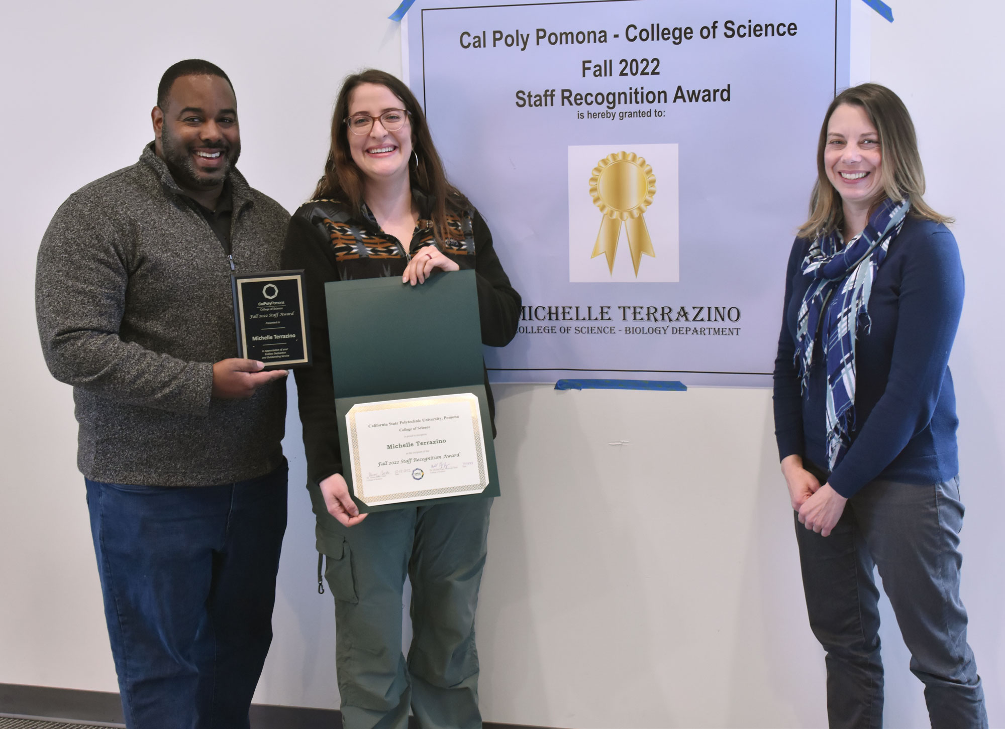 Associate Dean Michael Page joins staff award winner Michelle Terrazino and Chair Erin Questad.