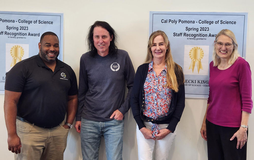 Staff Award winner Ian Carlson and Becki King pose with Dean Baski and associate dean Michael Page.