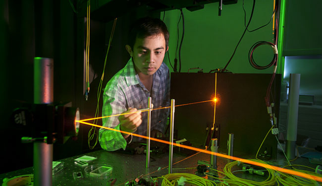 Student Michael Medrano works with an optical laser