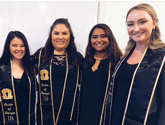 Members of a sorority pose with honor cords