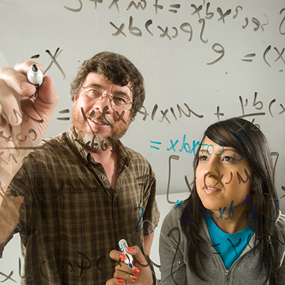 Professor working with student on math problems. 