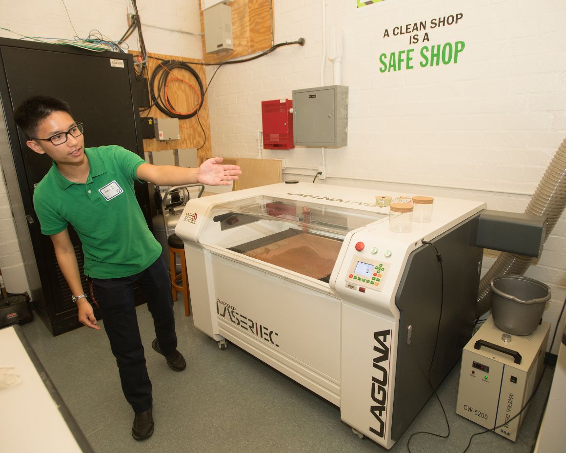 student presenting equipment to guest