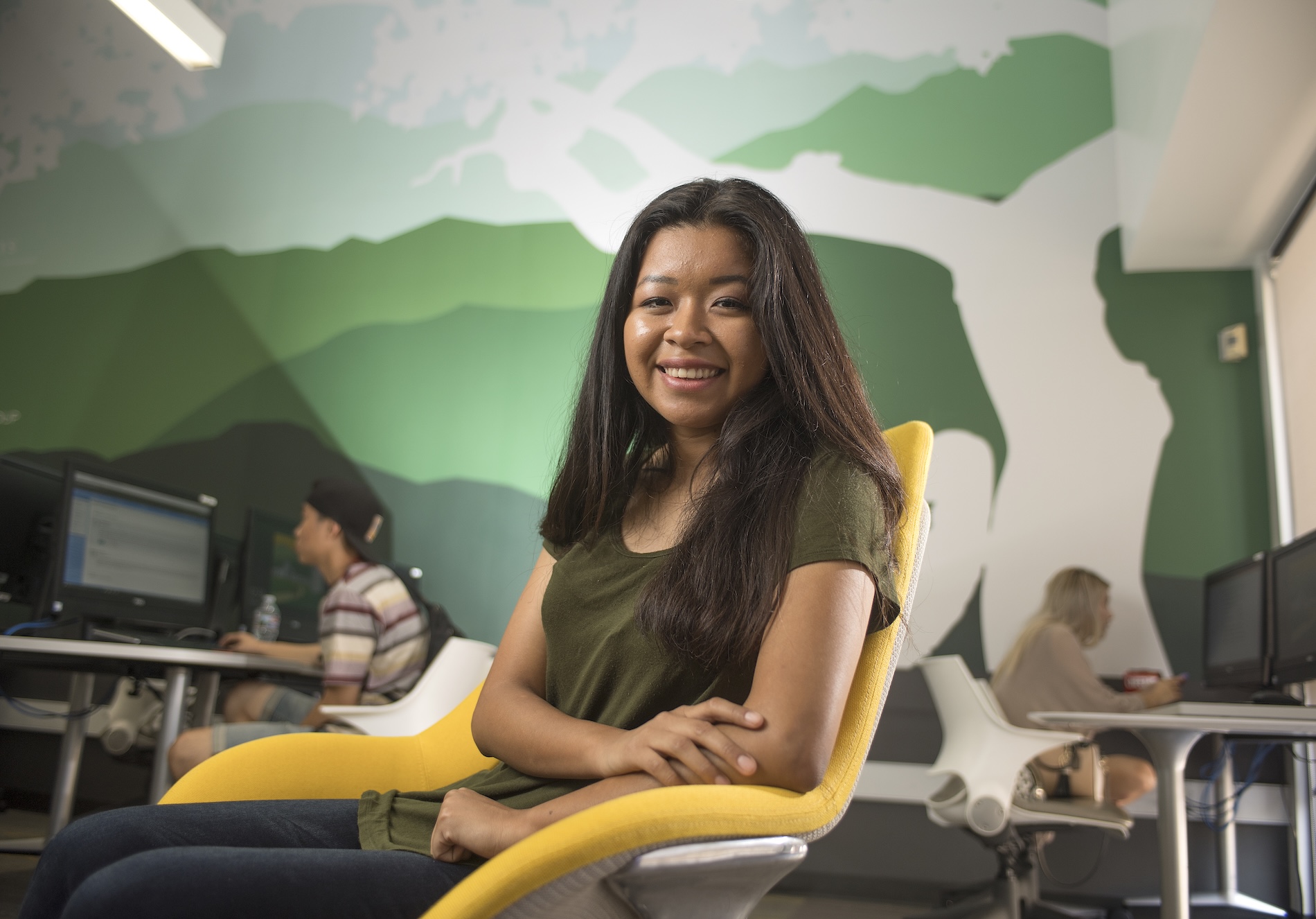 Former EOP Student smiling in a computer lab
