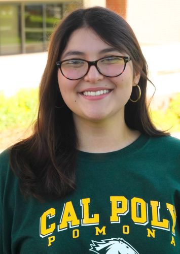 Woman wearing Cal Poly Pomona t-shirt smiling.