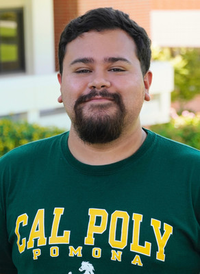 Man wearing Cal Poly Pomona t-shirt smiling.