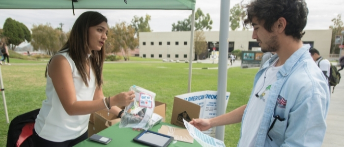 A student is handed a 'quit kit' during a campus event
