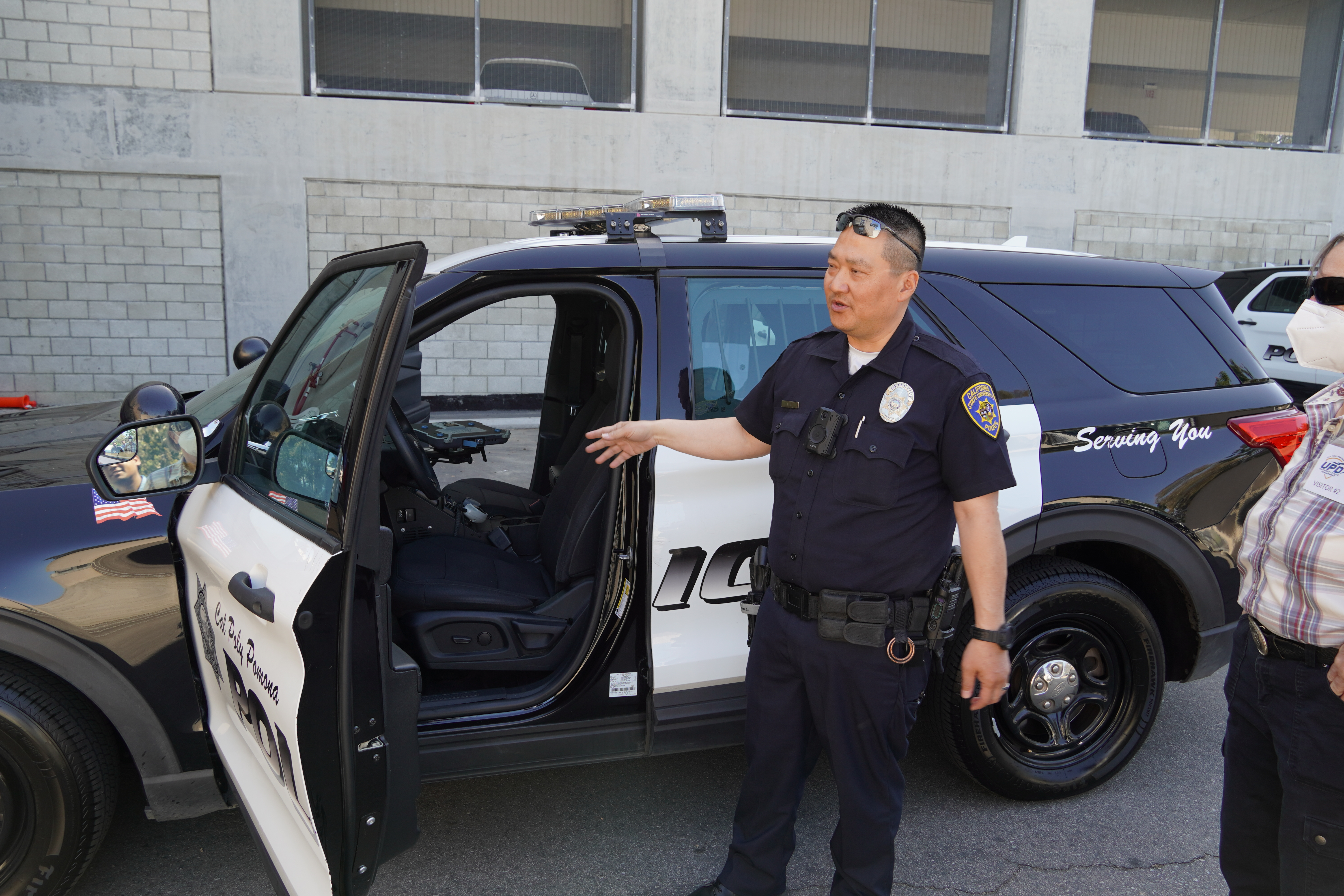 A UPD officer demonstrates features of the police vehicle