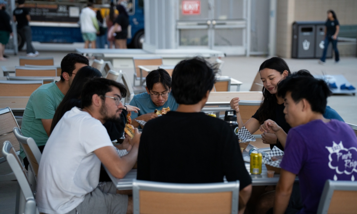 Students eat together at a Flick n Float event