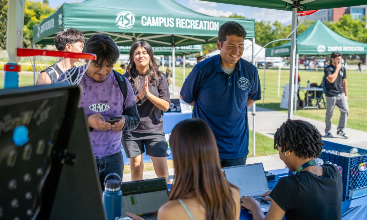 Students get more information at a National Voter Registration day Booth