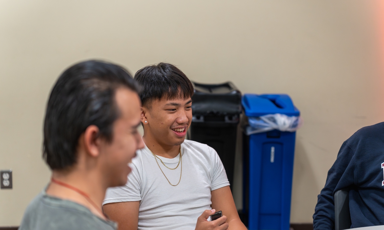 Two students talk at an ASI event