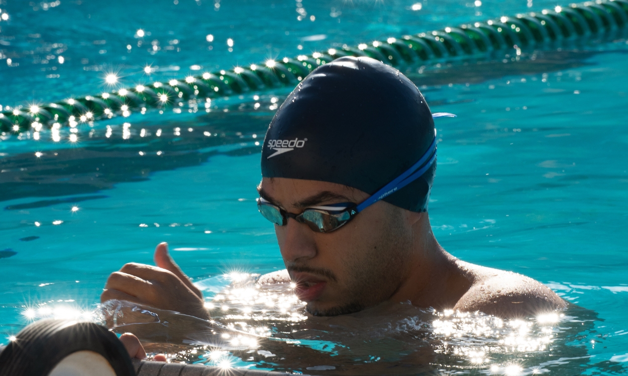 A swimmer comes up to the surface after a race