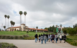 students on a campus tour in front of the old stables