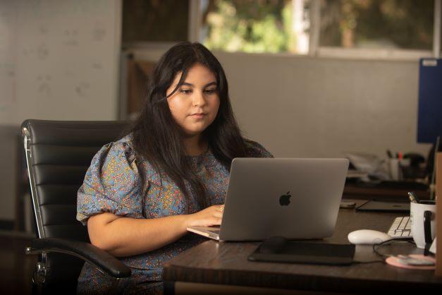 Student looks at a laptop