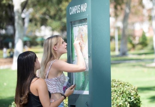 Two students look at a campus map