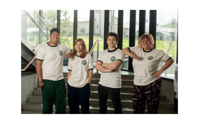 Group of 4 Bronco Scholars students pose wearing Bronco Scholars t-shirts