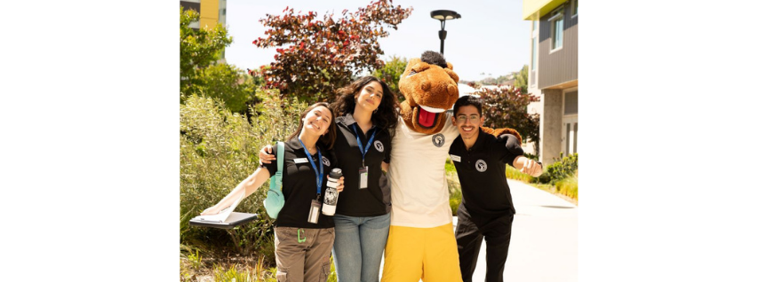 Three students pose with Billy